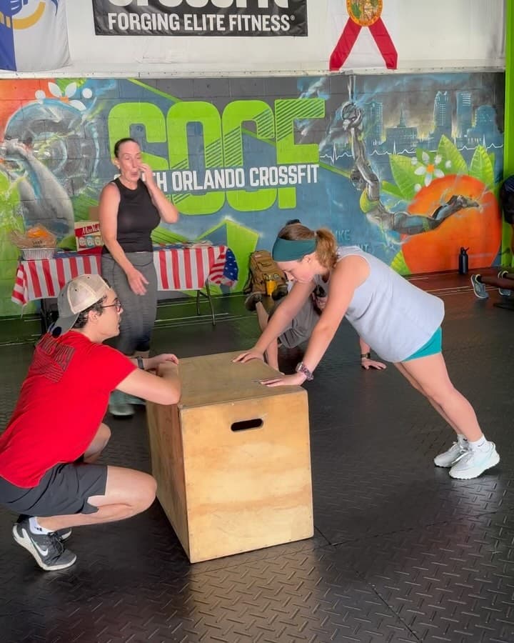 Coached box jump in front of the SOCF mural